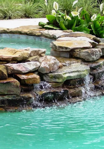 Waterfall from hot tub to pool with faux rocks