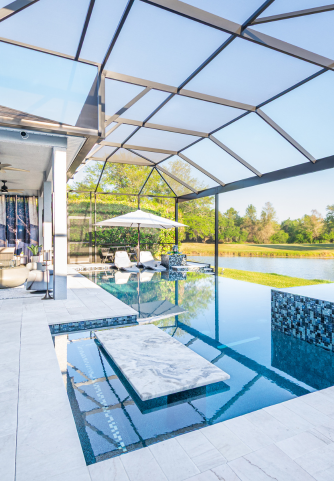 White marble infinity pool finish with sun shelf, spa, and table