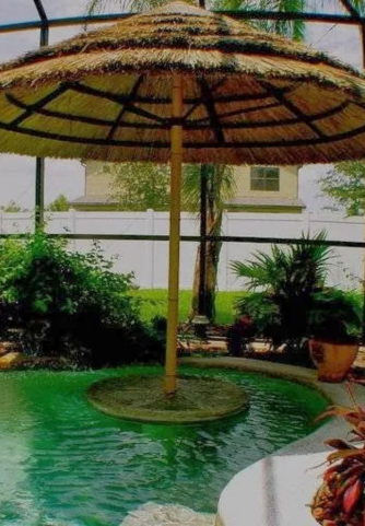 Small table with umbrella and seating around pool bar