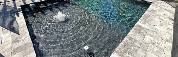 Pool water feature including bubbler and jet
