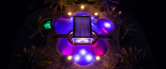 LED Lights and Fire Bowls light up pool at night time