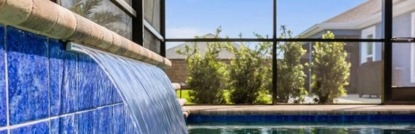Pool waterfall water feature spills into pool in Florida