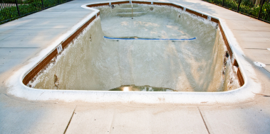 Drained pool with discoloration on the bottom