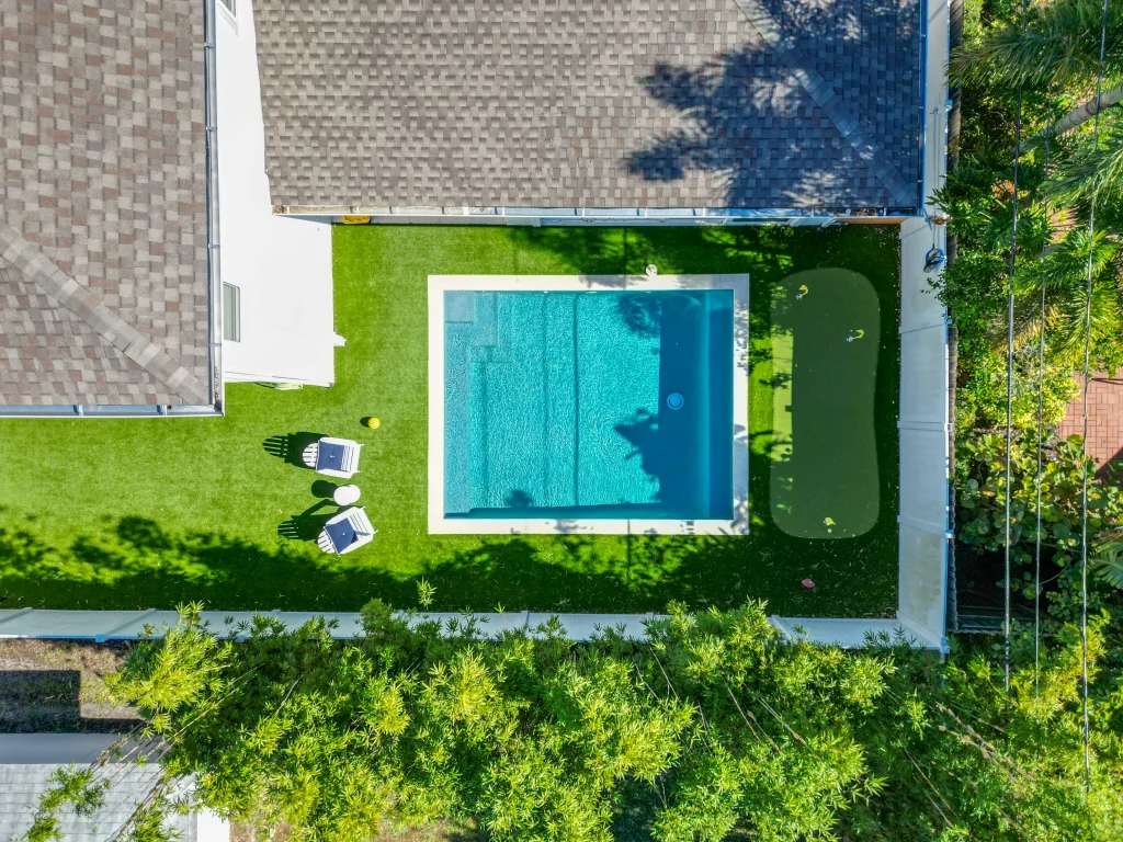 Small pool in Orlando Backyard with a putting green and seating