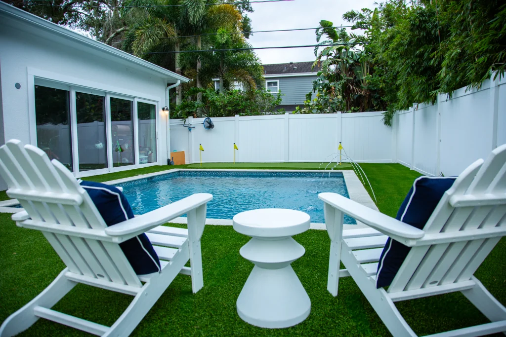 Small Pool Design with seating, water features and a putting green. 